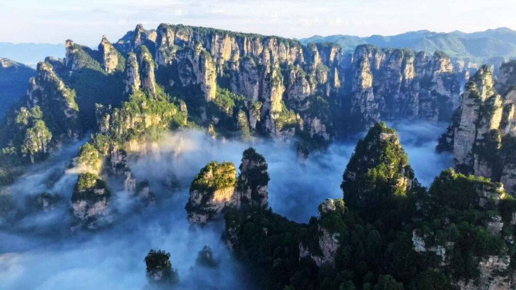 A mountainous landscape with jagged peaks and lush greenery. 3
