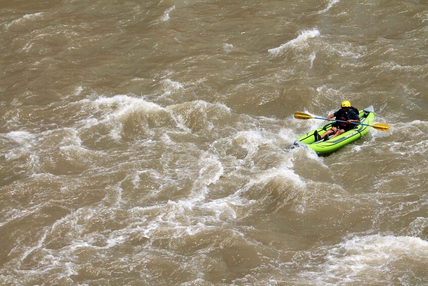 A person kayaking on a river. 3