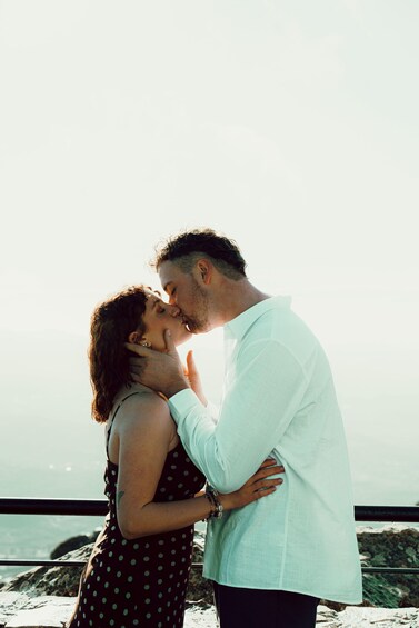A couple embracing by a rocky seaside. 3