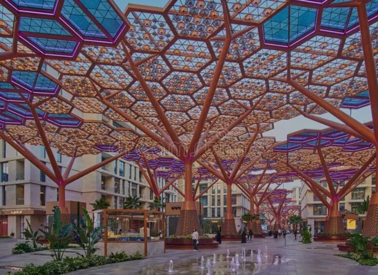 A modern architectural structure with geometric patterns and a water feature. 2