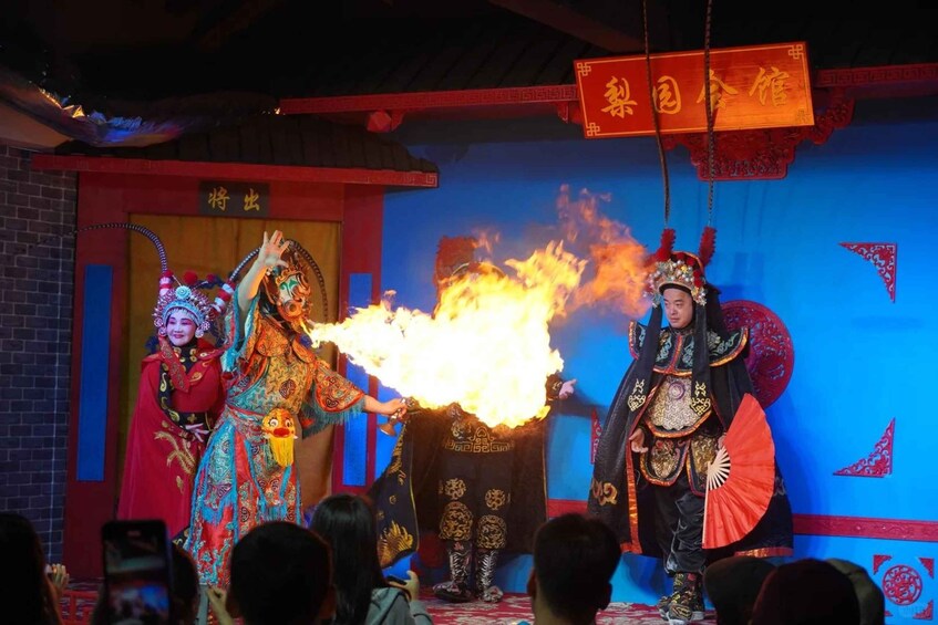 A cultural performance with performers in traditional costumes and a fire effect. 5