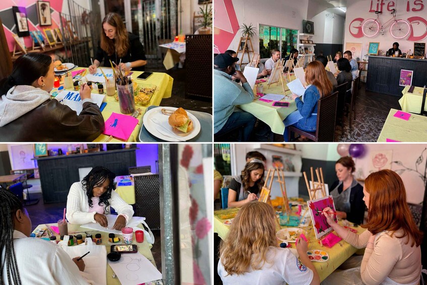 A group of people engaged in painting activities at a studio with tables, easels, and art supplies. 1