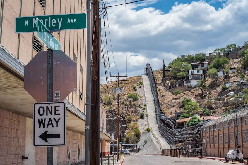 A street sign for 'N. Marley Ave' and a 'ONE WAY' sign with an arrow pointing left. 3