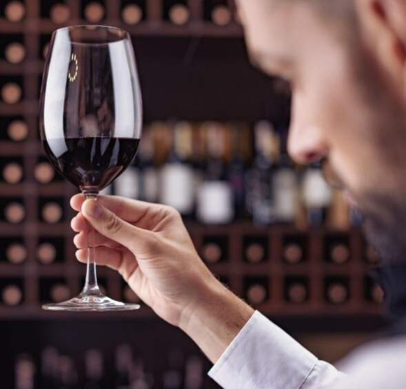 A person holding a wine glass. 1
