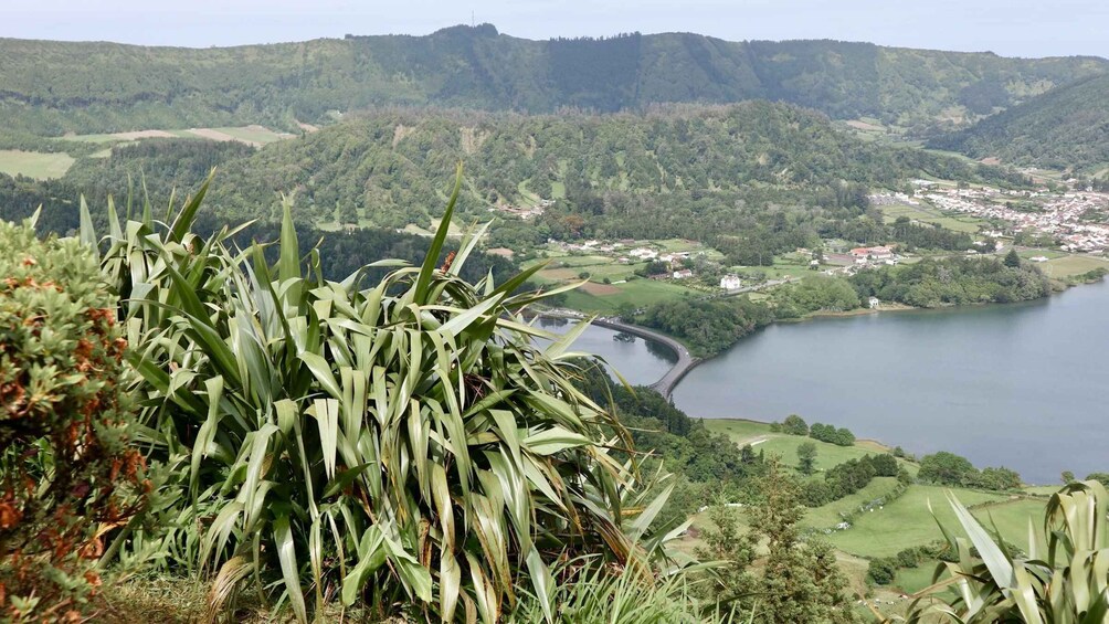 A lake surrounded by hills and a town. 4