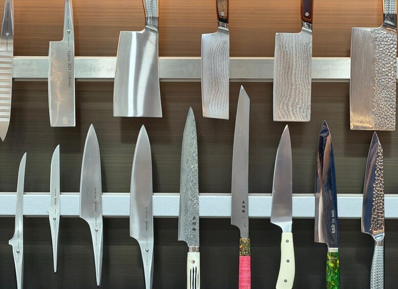 A variety of knives displayed on a wall. 4