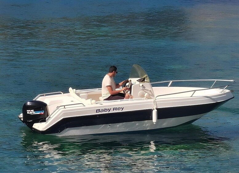 A small motorboat named 'Baby Rey' on calm water. 5