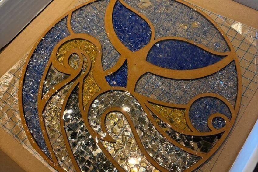 A mosaic with geometric patterns and reflective surfaces. 3