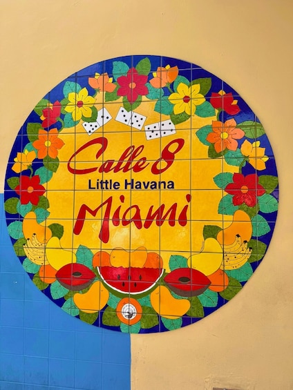 A colorful circular mosaic with 'Calle 8 Little Havana Miami' text and various fruit illustrations. 2