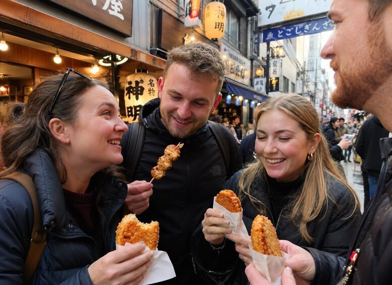 A group of people enjoying street food in an urban setting. 1