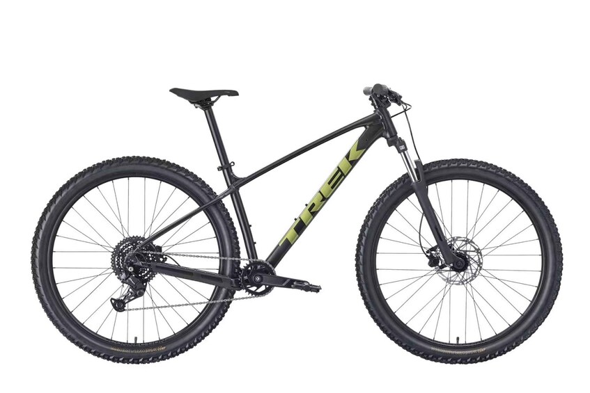 A mountain bike with a black frame and green accents, equipped with a front suspension fork and disc brakes. 2