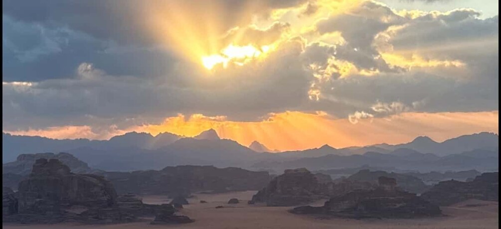 A desert landscape with mountains in the background and a sunset. 5