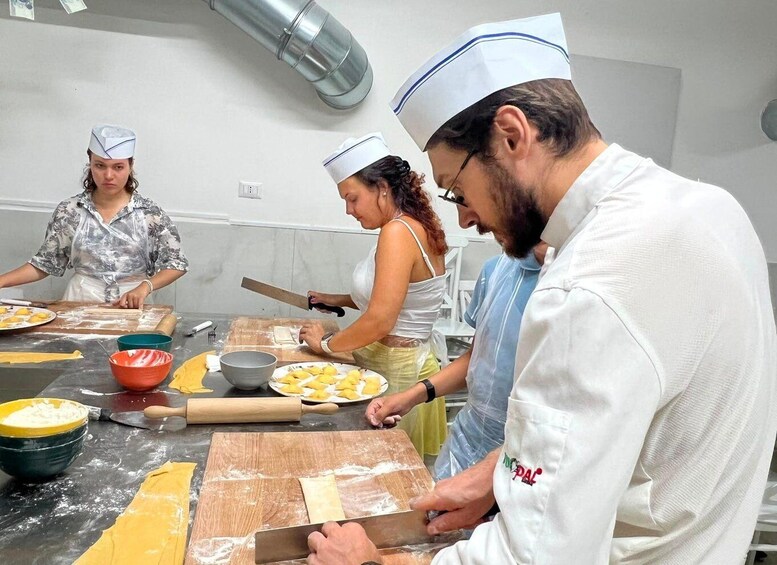 A group of chefs preparing food in a kitchen. 5