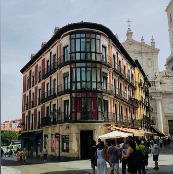 A multi-story building with a curved facade, large windows, and balconies. 2