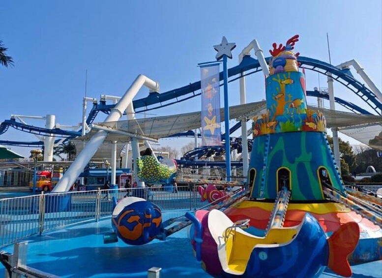 A colorful amusement park ride with a blue and yellow design, a large spherical structure, and a star-shaped top. 3