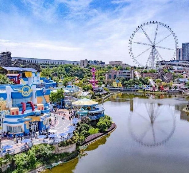 A water park with a Ferris wheel, a lake, and colorful buildings. 1