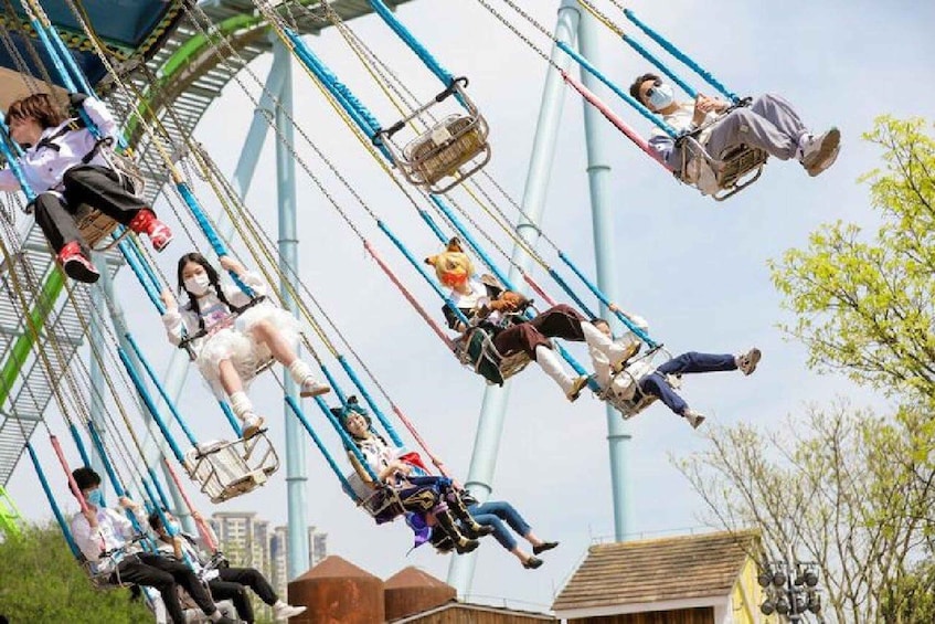 A Ferris wheel with people seated in the cabins. 2