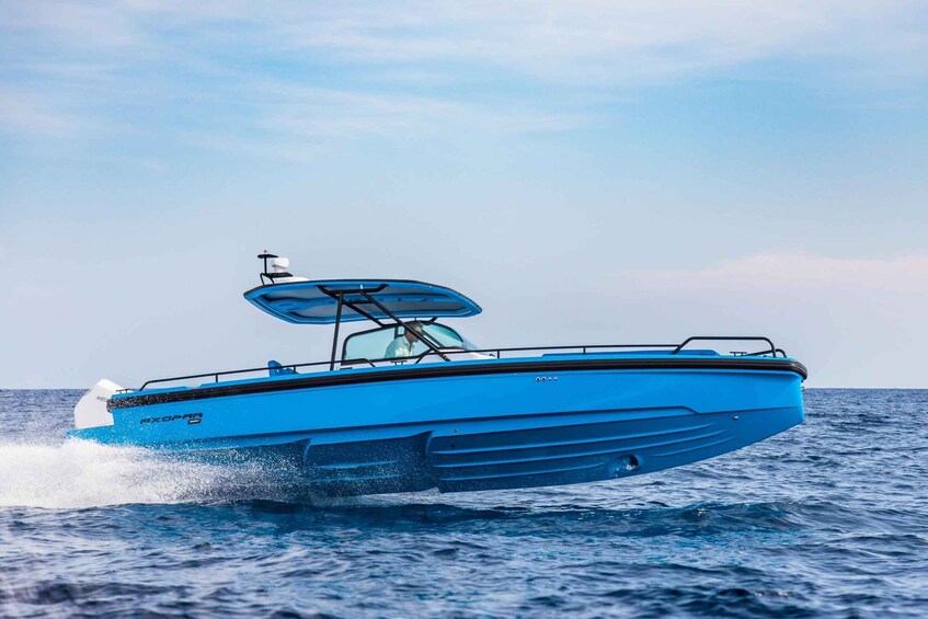 A blue speedboat with a canopy, moving through calm waters. 2