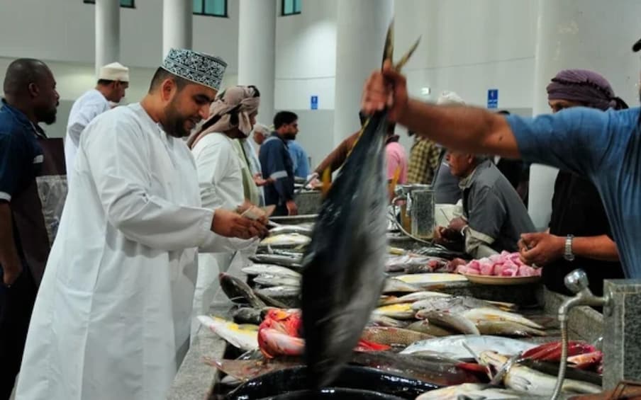 A fish market with people handling fish. 1