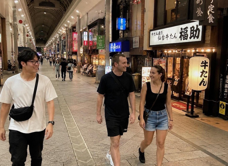 A busy pedestrian street with shops and signs in a foreign language. 1