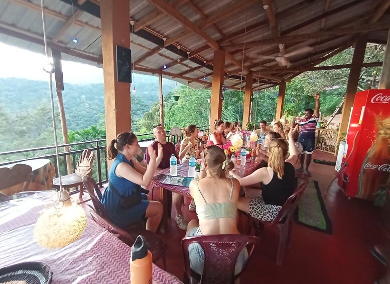 A group of people dining at an outdoor restaurant with a view of the mountains. 4