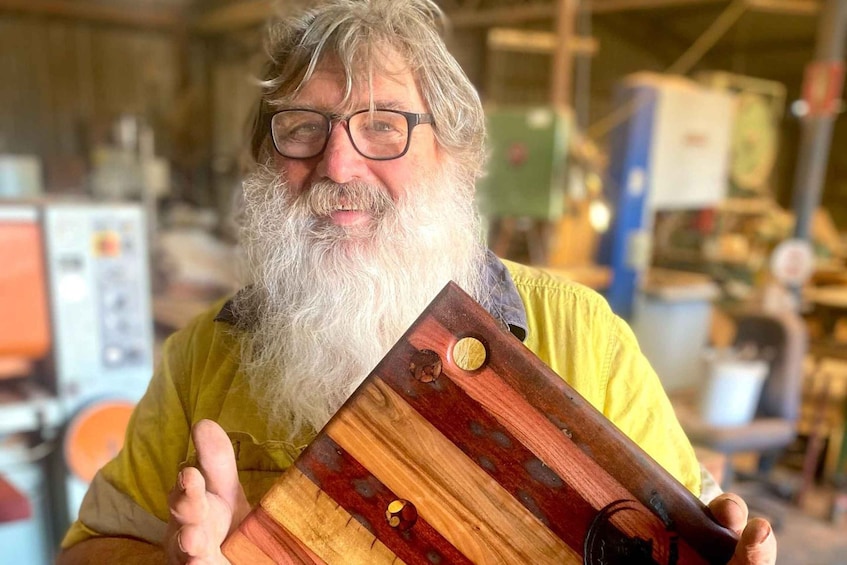 A person holding a wooden object with a unique design. 5