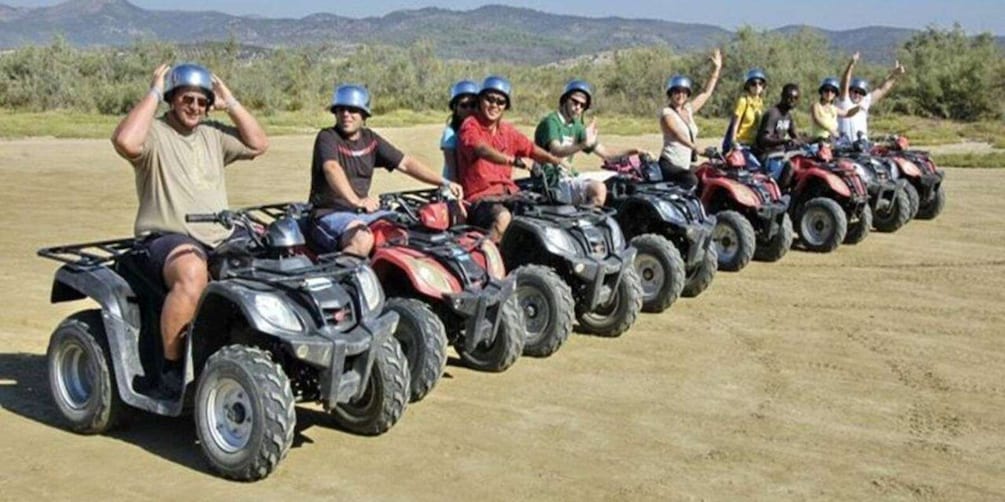 A group of people on ATVs in a line formation. 1