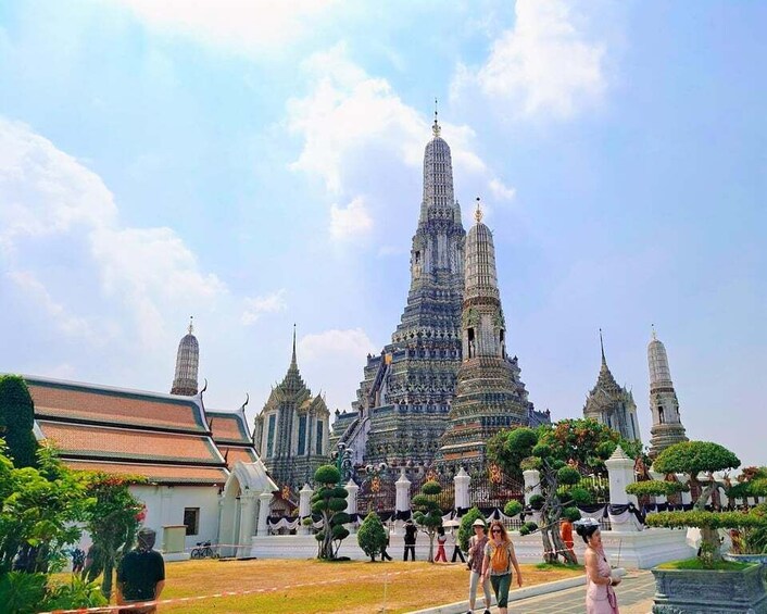 A large, ornate temple complex with multiple spires and a central tower, surrounded by well-maintained gardens and pathways. 1