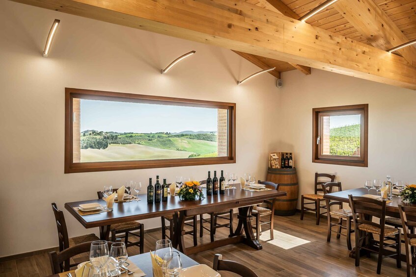 A dining area with a large window overlooking a golf course. 1