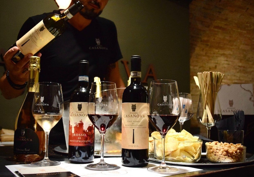 A wine tasting event with various bottles and glasses of wine. 1