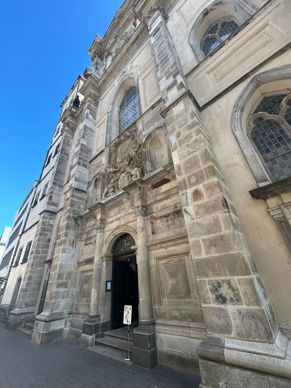A historic stone building with ornate carvings and arched windows. 3