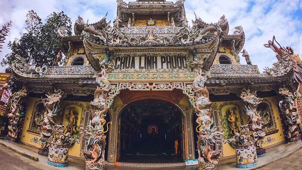A temple entrance with ornate decorations and statues. 5