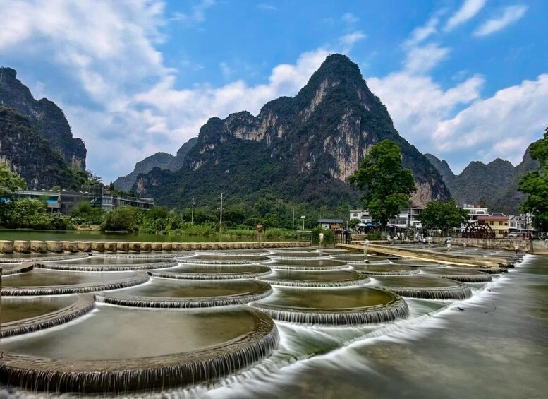 Terraced water gardens, a mountain, and a small settlement. 2