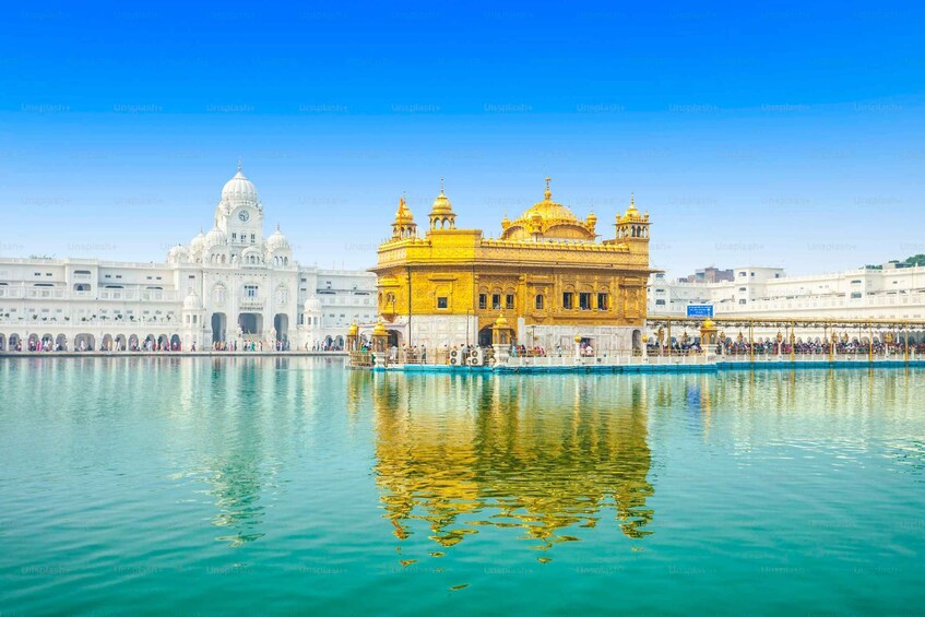 The Golden Temple and the Akal Takht in Amritsar, India, with a reflection in the water. 1
