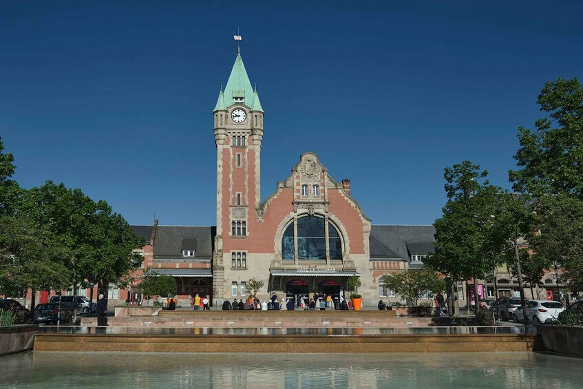 A historic building with a clock tower and a large arched entrance. 2