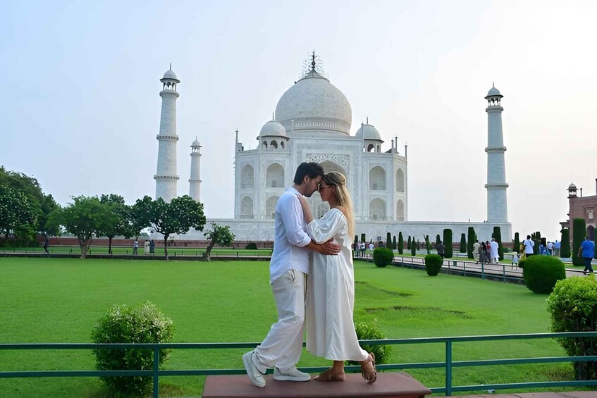 A couple embracing in front of the Taj Mahal. 2