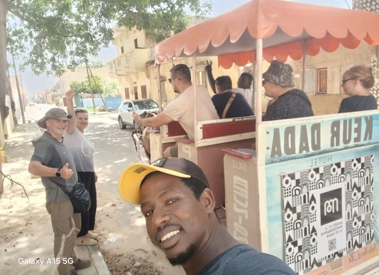A street food cart with a sign reading 'KUR DADAG' and a man in a cap taking a selfie. 1