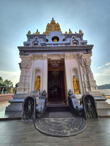 A temple with golden statues, intricate carvings, and a central entrance. 1
