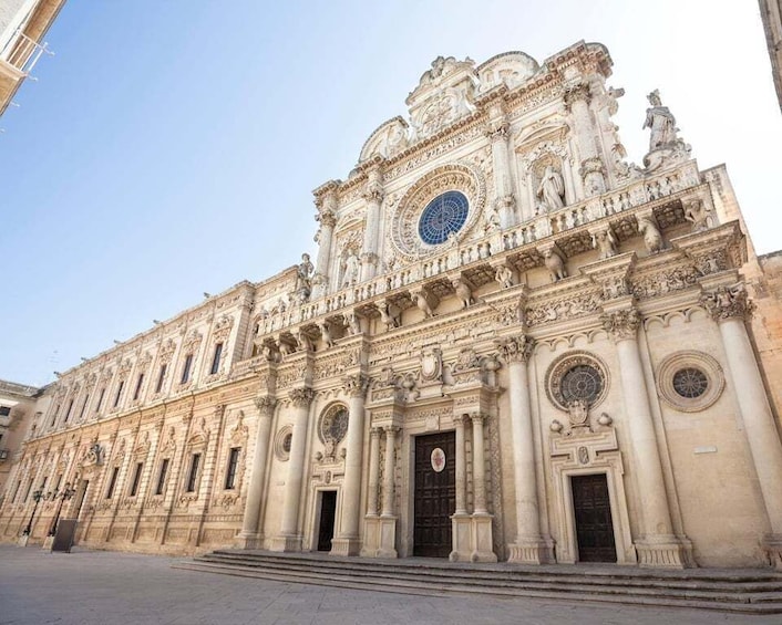 A grand, ornate building with intricate carvings and a large circular window. 4