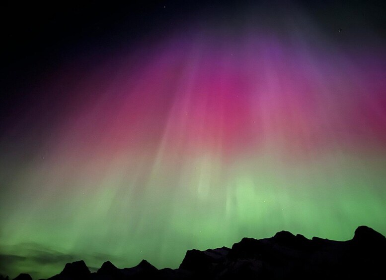 The Northern Lights over a mountain range. 5