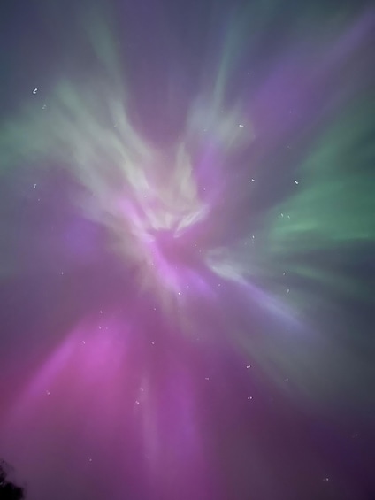 A vibrant aurora borealis display with green and pink hues. 2