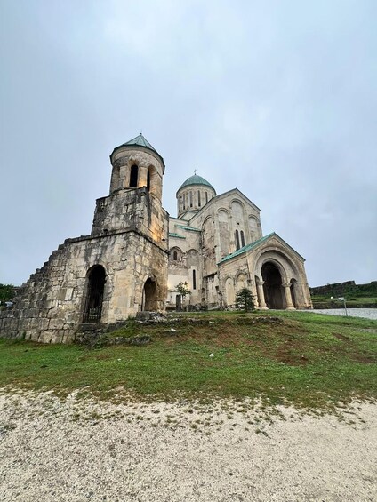 An ancient stone church with a bell tower and a dome. 5