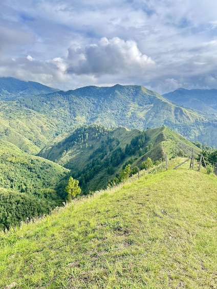 A mountainous landscape with lush greenery and a clear sky. 1