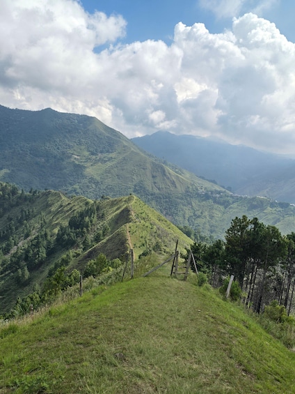 A mountainous landscape with lush greenery and a clear sky. 3