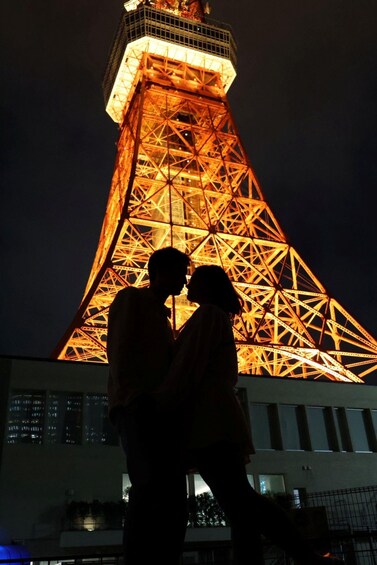 A silhouette of a couple against the Eiffel Tower at night. 1