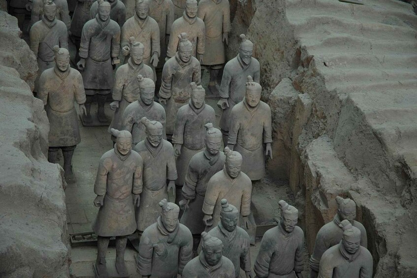 A collection of terracotta soldiers in a trench formation. 1