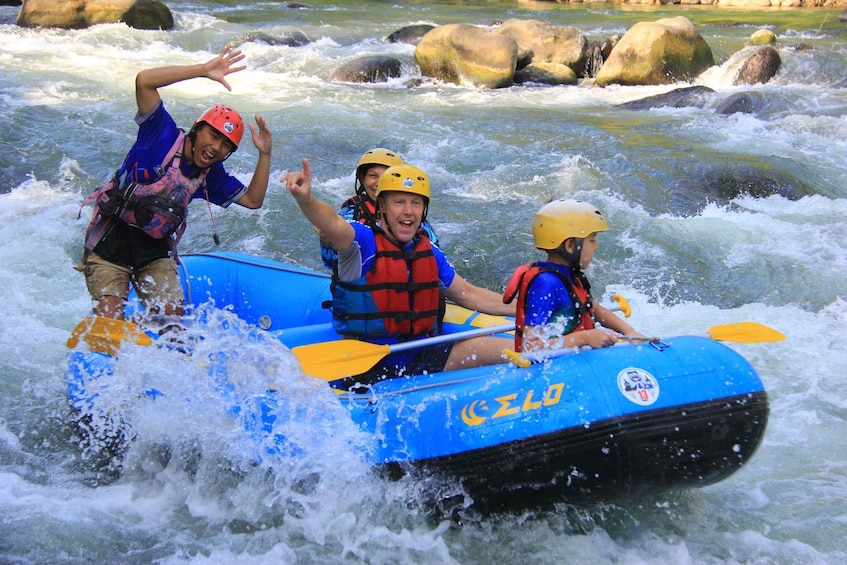 A group of people rafting on a river with rapids. 5