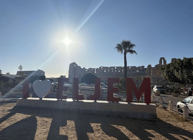 A sunny day with the sun shining, palm trees, and the word 'ELLEM' in large letters. 5