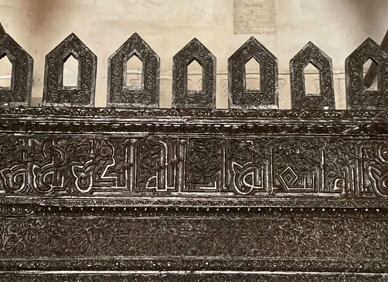 A detailed architectural wall with ornate carvings and geometric patterns. 2