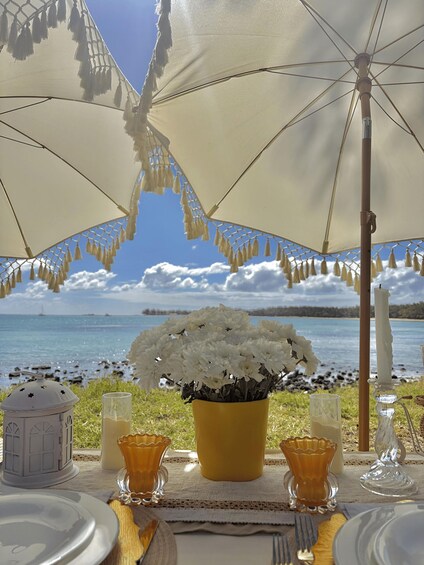 A table set for a meal with a view of a lake and sky. 3